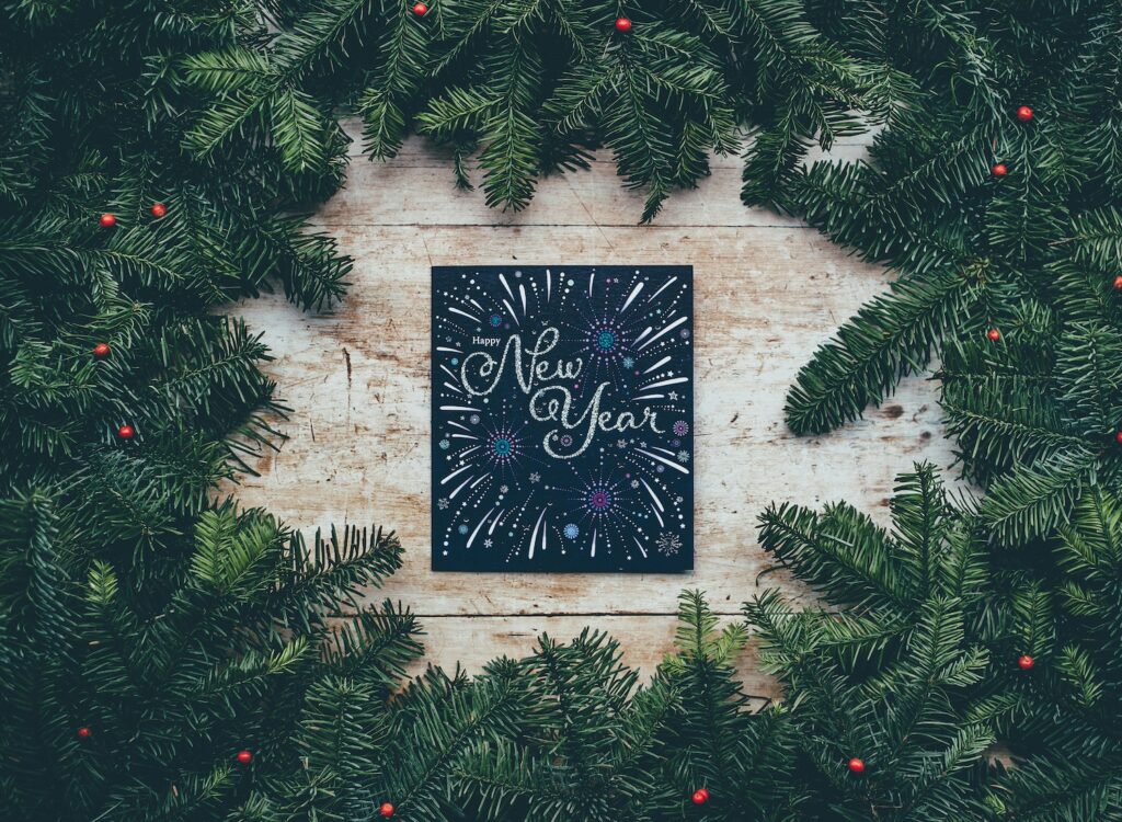 Happy New Year poster surrounded by holly