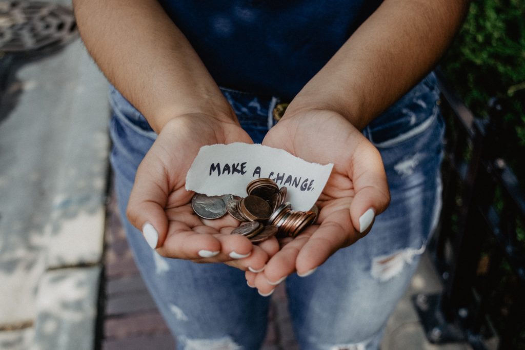 girl holding change to make a difference