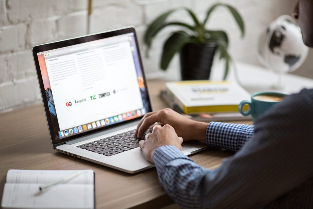 Man using a laptop to reach out to sponsors.