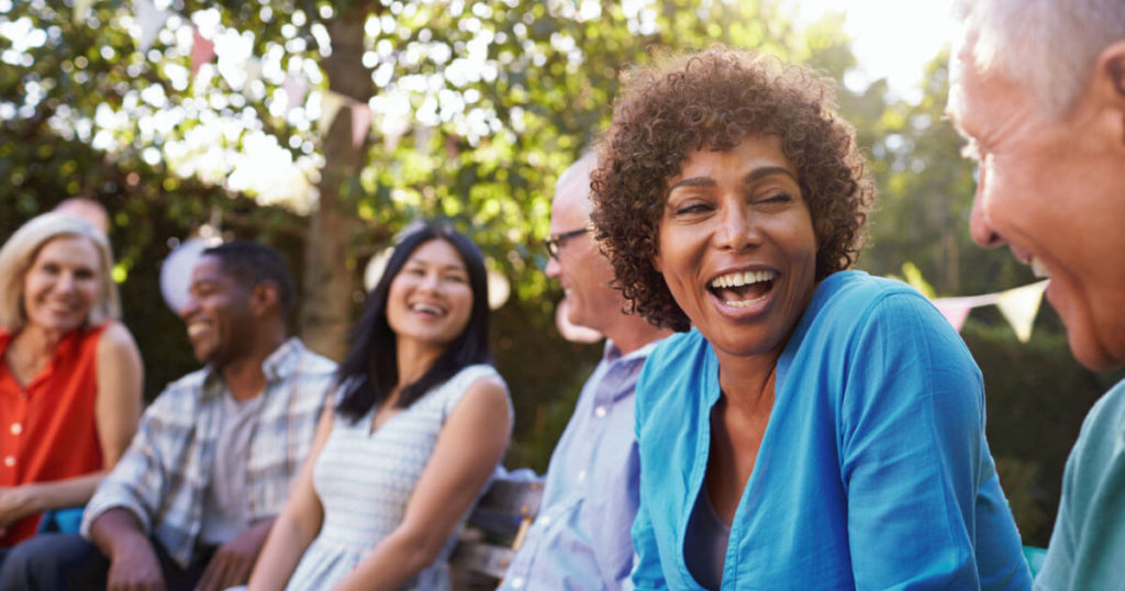 Group of people sitting outside and laughing