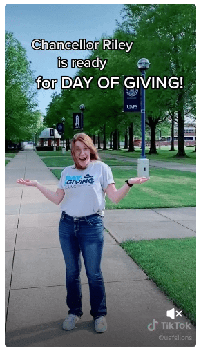 University of Arkansas promotes their text to donate keyword for their Day of Giving campaign in the caption of their TikTok video