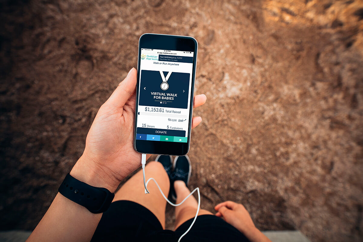 Person holding a phone showing a virtual walk/run tracker