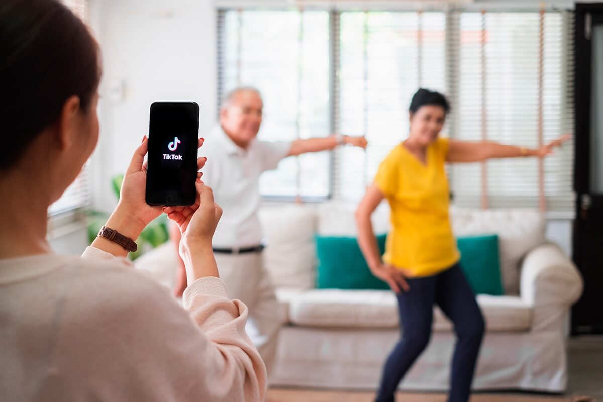 Two individuals being recorded by someone using TikTok