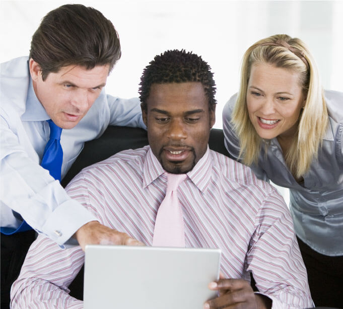 3 people staring at a laptop screen