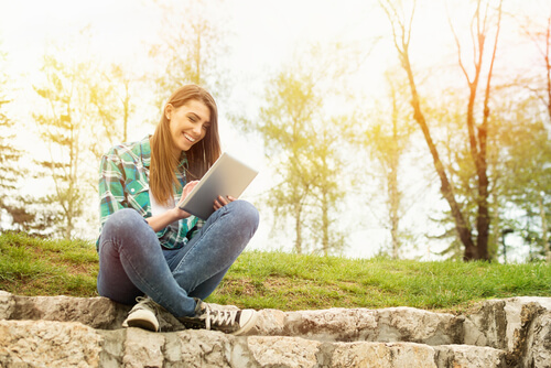 Person sitting on stones outside