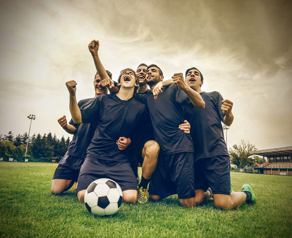 group of soccer players celebrating