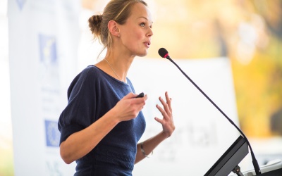 young woman speaking into microphone 