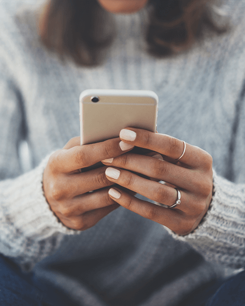 Woman holding a phone with both hands