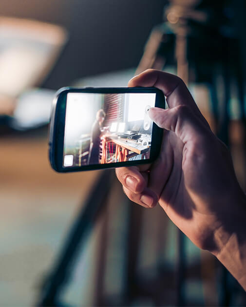 Individual holding a phone for a livestream