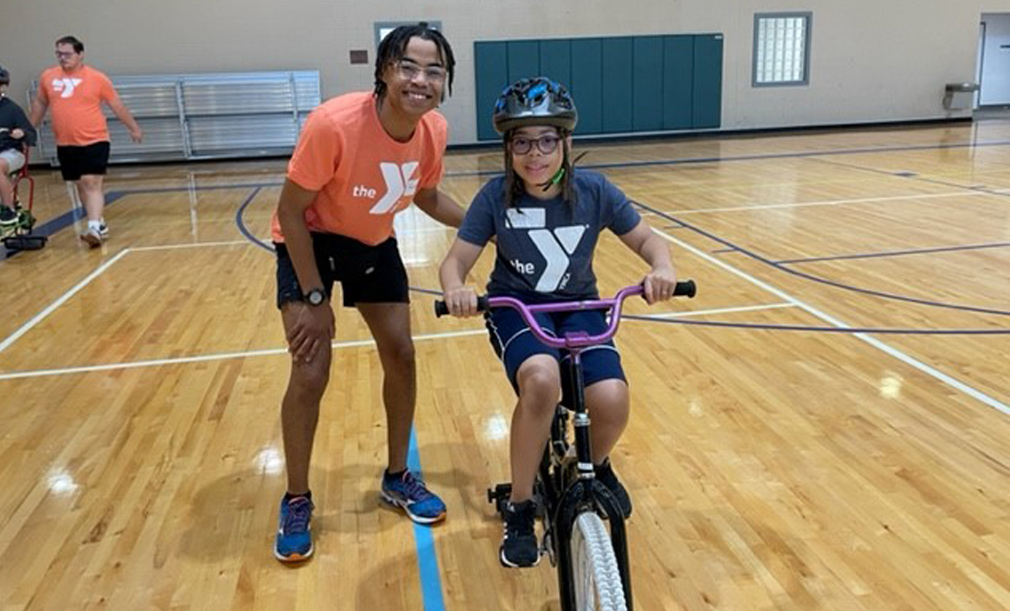 YMCA Greenville Body Image 3 YMCA-volunteer-with-child-on-bike